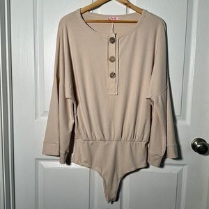 Pink lily beige ribbed bodysuit. Snaps. Bell sleeve. Size small.
